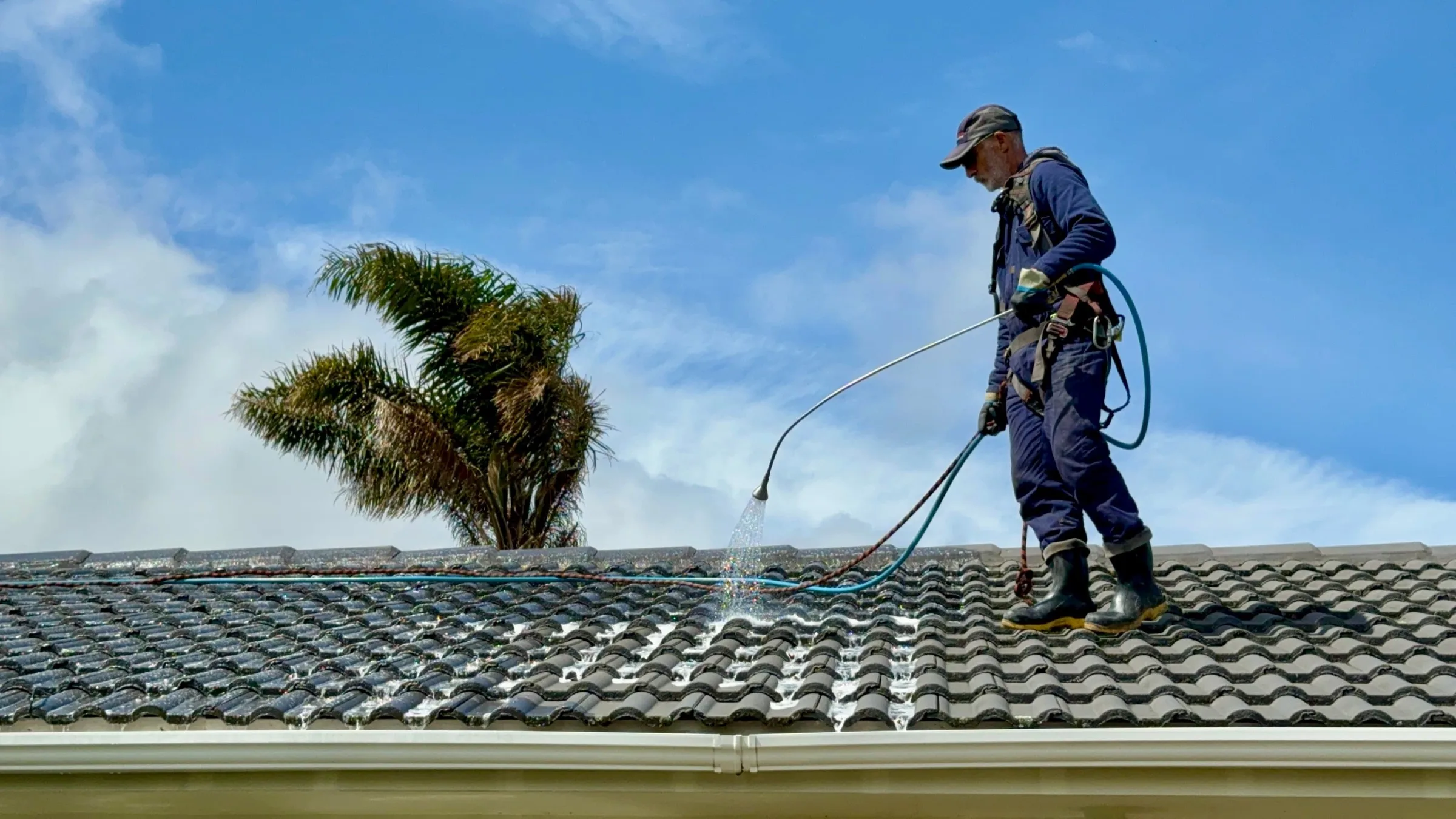 Roof treatment being sprayed onto a roof