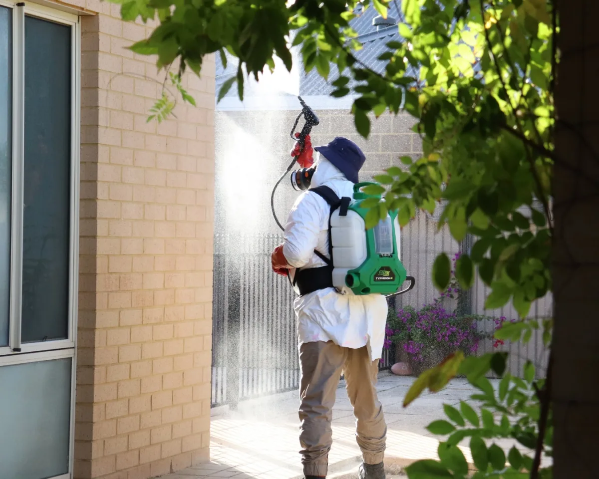 Spider treatment being sprayed under the eaves
